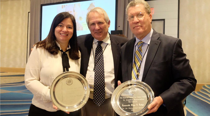 La Jueza Presidenta Hon. Maite D. Oronoz Rodríguez recibe el premio “Distinguished Service Award” de manos del Hon. Paul Reiber, Presidente del Conference of Chief Justices y Juez Presidente del Tribunal Supremo de Vermont. A la derecha el Hon. Rhys Hodge, Juez Presidente del Tribunal Supremo de las Islas Vírgenes quien también recibió un reconocimiento La Jueza Presidenta Hon. Maite D. Oronoz Rodríguez recibe el premio “Distinguished Service Award” de manos del Hon. Paul Reiber, Presidente del Conference of Chief Justices y Juez Presidente del Tribunal Supremo de Vermont. A la derecha el Hon. Rhys Hodge, Juez Presidente del Tribunal Supremo de las Islas Vírgenes quien también recibió un reconocimiento