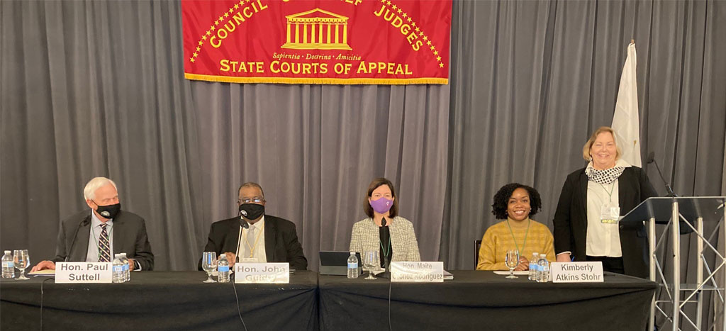De izquierda a derecha, el Presidente del Conference of Chief Justices y Juez Presidente de Rhode Island, Hon. Paul Suttell; el Juez del Primer Circuito de Apelaciones de Luisiana, Hon. John Michael Guidry; la Jueza Presidenta del Tribunal Supremo de Puerto Rico, Hon. Maite D. Oronoz Rodríguez; la periodista del Boston Globe, Kimberly E. Atkins Stohr; y la Jueza Presidenta del Tribunal de Apelaciones de Kansas, Hon. Karen Arnold-Burger. De izquierda a derecha, el Presidente del Conference of Chief Justices y Juez Presidente de Rhode Island, Hon. Paul Suttell; el Juez del Primer Circuito de Apelaciones de Luisiana, Hon. John Michael Guidry; la Jueza Presidenta del Tribunal Supremo de Puerto Rico, Hon. Maite D. Oronoz Rodríguez; la periodista del Boston Globe, Kimberly E. Atkins Stohr; y la Jueza Presidenta del Tribunal de Apelaciones de Kansas, Hon. Karen Arnold-Burger.